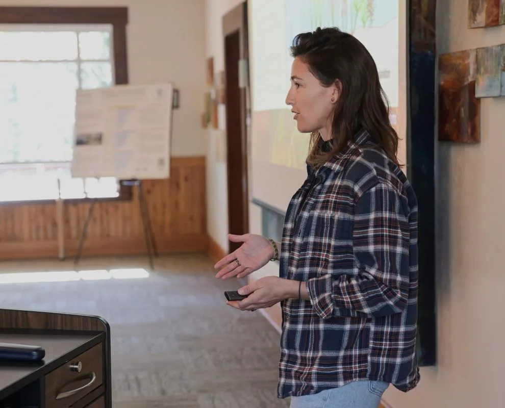 A lightning talk speaker gestures while presenting slides.